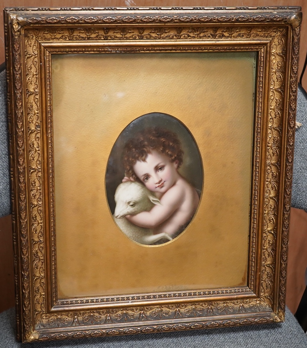 A German oval porcelain plaque with putto and lamb, possibly KPM, ornately gilt framed, overall 39 x 33cm. Condition - fair